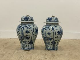 A pair of Chinese blue and white porcelain baluster vase and covers, each decorated with yuan motifs