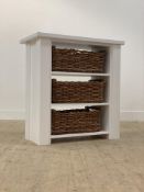 A modern white painted three height shelf unit with wicker basket drawers, (a-symmetric shaped