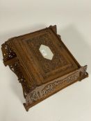 An Early 20th century carved and pierced oak wall mounted medicine or bathroom cabinet, having a