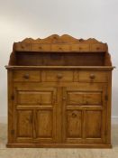 A Victorian style Scotch stained cedar wood dresser, the raised serpentine back fitted with five