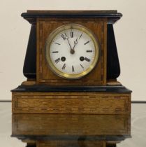 A late 19th / early 20th century mantel clock, the oak and ebonised case with chequered inlay