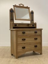 An early 20th century Art Nouveau period satin walnut dressing chest, the back with pierce carved