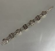 A Scottish silver rampant Lion and Celtic Targe alternating chain link bracelet, (D x 9 cm). 23g