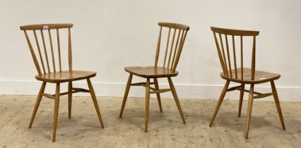 Ercol, a set of three beech and elm model 737 chairs, with comb backs, shaped seats and raised on