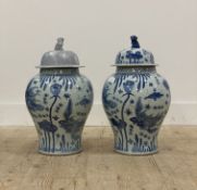 A pair of Chinese blue and white porcelain baluster vase and covers, each decorated with yuan
