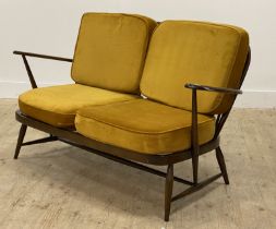 Ercol, a vintage two seat sofa, with hoop and spindle back, and open arms enclosing yellow velvet