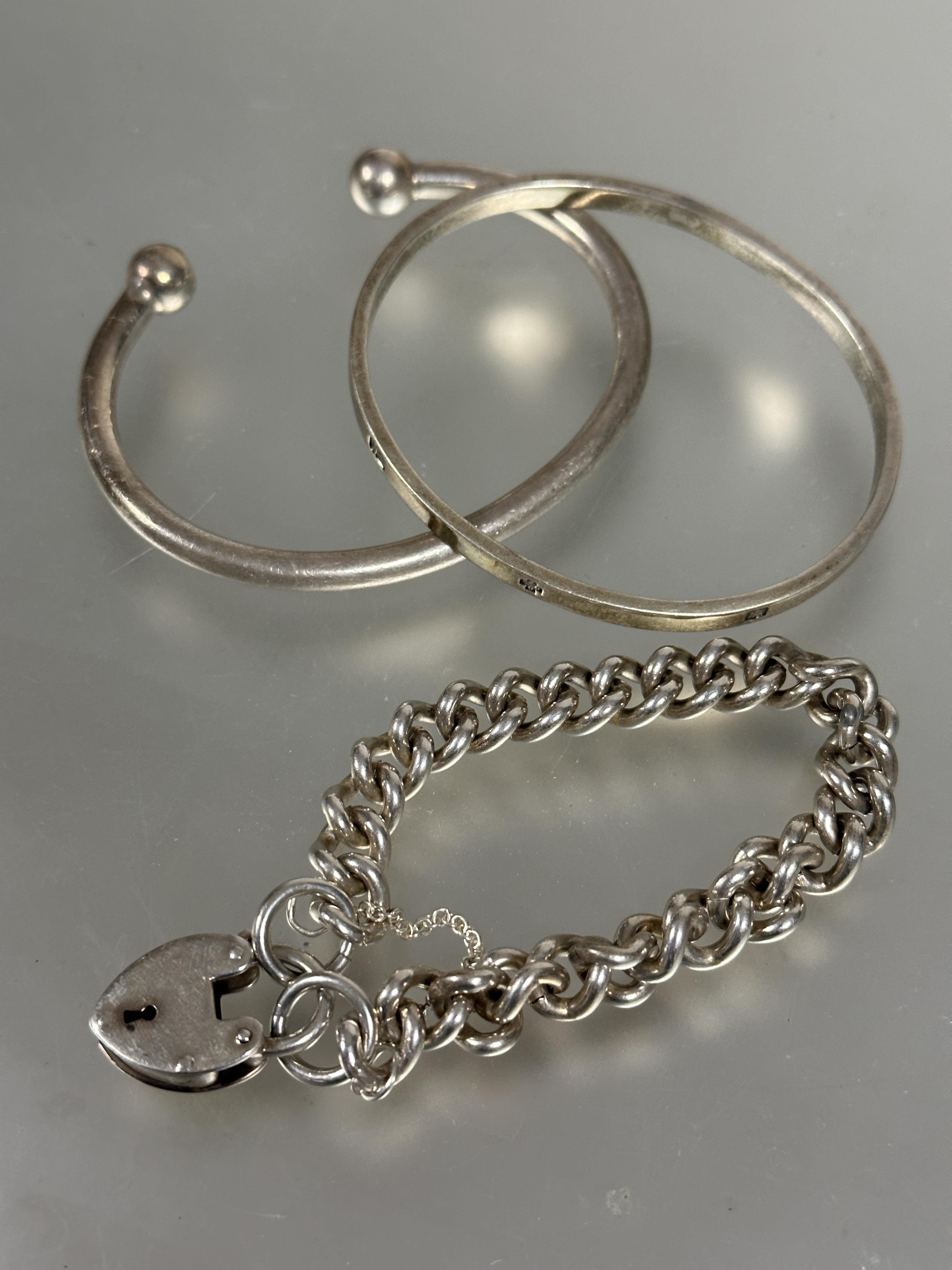 A silver curb link chain bracelet complete with heart shaped padlock and safety chain, (D x 7 cm), A