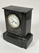 A Victorian black slate mantle clock with moulded top, engraved panel to front and white enamel dial