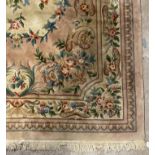 A Chinese super washed wool carpet, the pink ground with floral motifs 395cm x 274cm.