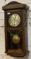 A 1930's Junghans regulator wall clock, the stained and carved case with bevel glazed and brass