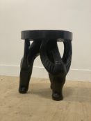 A carved and ebonised hardwood lamp table, the circular top raised on three supports formed as