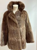A Lady's Musquash fur jackets with folded collar and slash pockets to side and satinised lining
