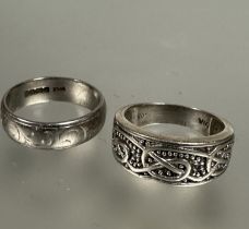 A 18ct white gold engraved ring,T, 7.9g and a 9ct white gold Celtic knot cuff style ring, Q/R, 6.2g.