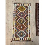 A hand knotted  chobi kilim runner rug of all over geometric design with an ivory border 143cm x