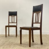 A pair of early 20th century Arts and Crafts period oak chairs in the manner of Liberty & Co. each