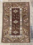 A hand knotted Turkish rug in a brown and red palette, of typical design 142cm x 96cm