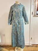A 1960's turquoise and gold lurex full length evening dress with collar and hidden zip to to front (