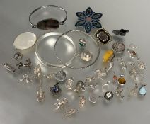 A collection of silver and white metal charms including a hedgehog,lion, top-hat, tankard, ballet