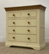 An oak and cream laminate two over three chest of drawers H99cm, W98cm, D44cm.