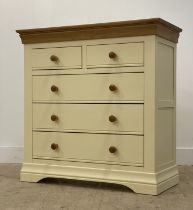 An oak and cream laminate two over three chest of drawers H99cm, W98cm, D44cm.