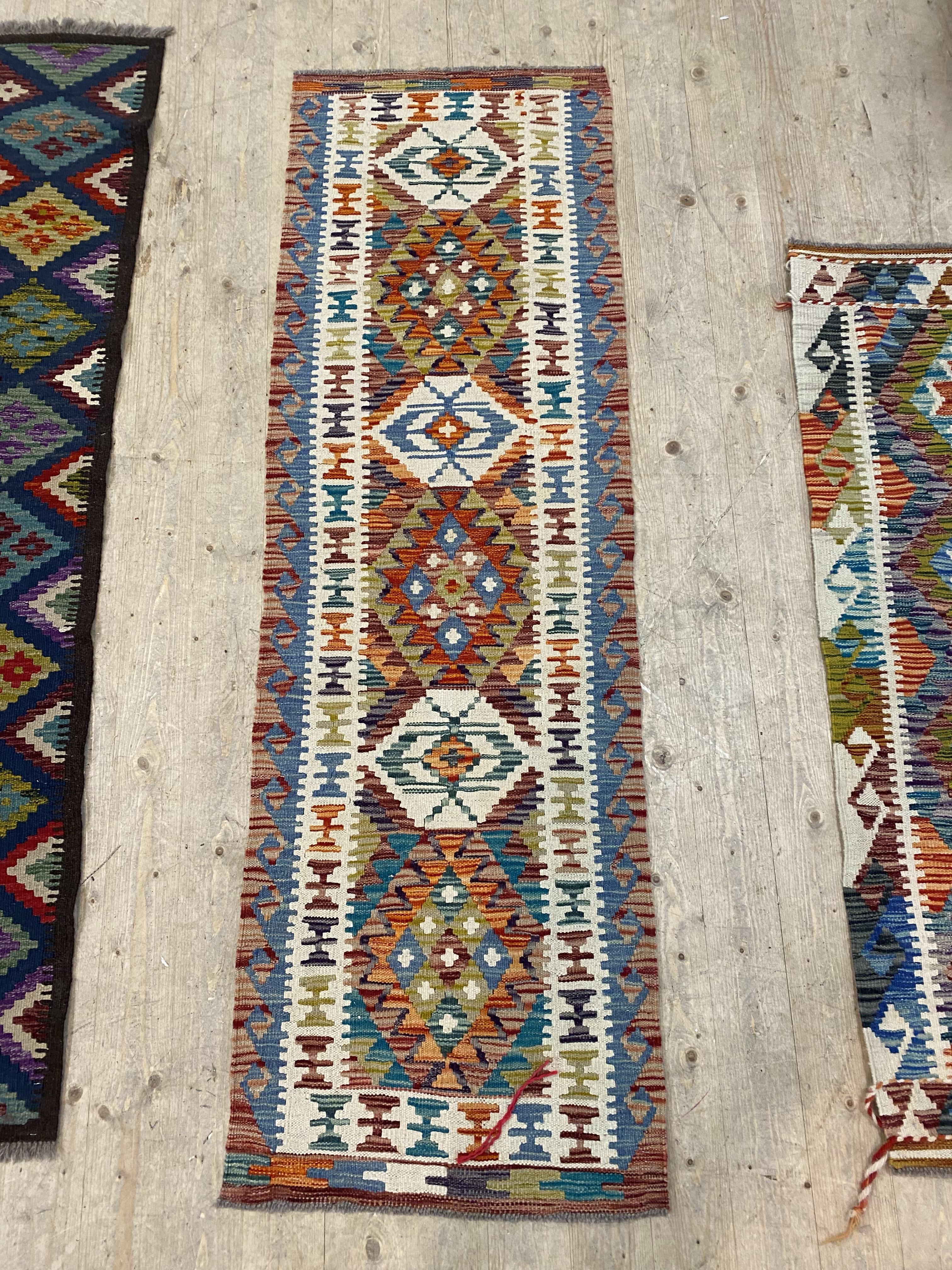 A hand knotted  chobi kilim runner rug of characteristic design with a running dog border 197cm x
