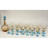 A complete set of blue stemmed and orange glassware comprising eight champagne flutes (19cm),