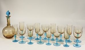 A complete set of blue stemmed and orange glassware comprising eight champagne flutes (19cm),