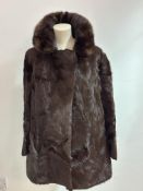 A vintage Astrakhan brown fur jacket with Mink faced collar, side slash pockets and satinized lining
