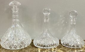 Three cut lead crystal ship's decanters of various shapes and design (largest h- 33cm)