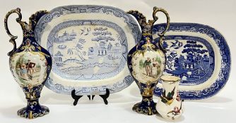 A mixed group of ceramics comprising a pair of decorative ewers with baroque style decoration and tr