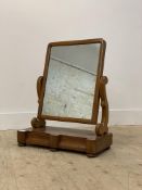 A Victorian mahogany vanity mirror, the rectangular mirror swivelling between two scrolled uprights,
