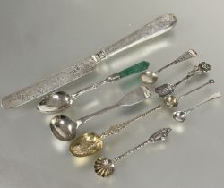 A collection of six various white metal and silver salt and mustard spoons, including a Georgian