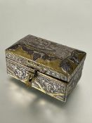 A Middle Eastern miniature brass jewellery casket of domed form, with white metal overlaid script