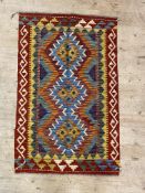 A hand knotted  chobi kilim rug with pole medallion within a running dog border 121cm x 76cm