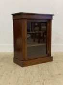 A 19th century mahogany pier cabinet of small proportions, the glazed door opening to shelves to