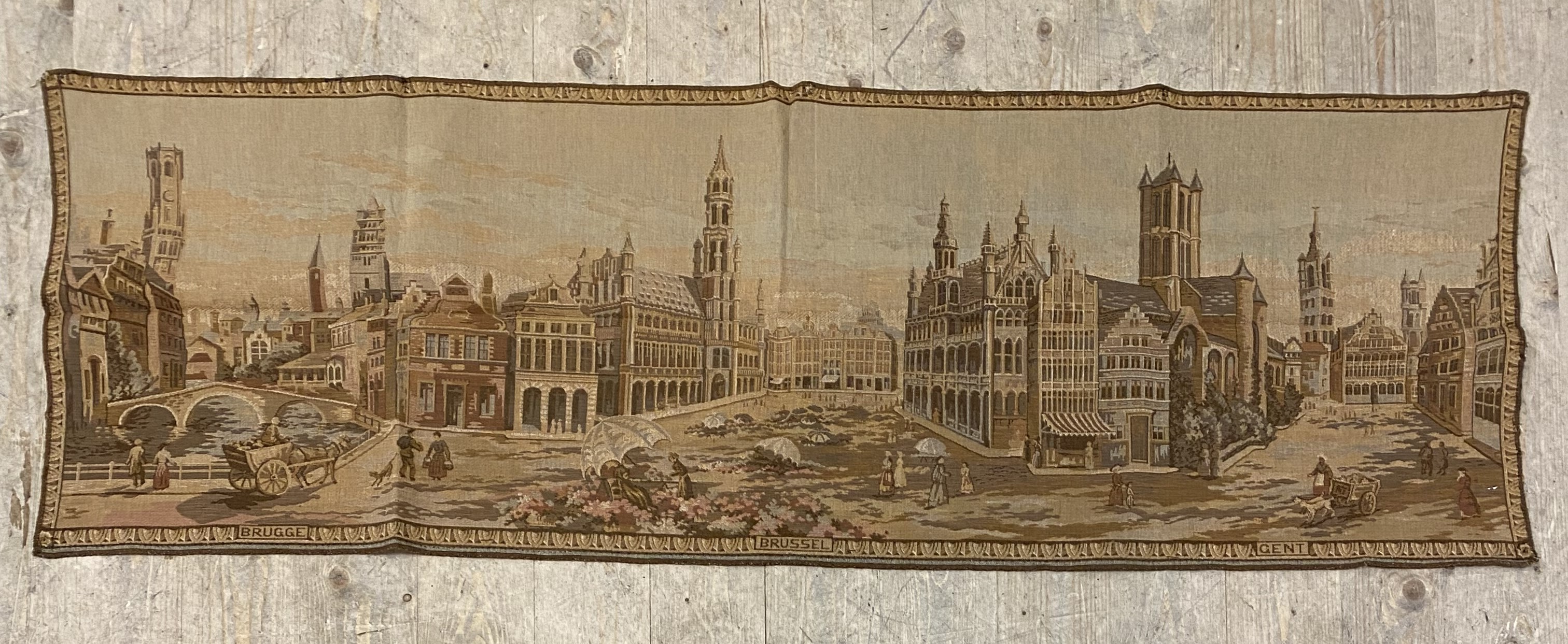 A French style tapestry wall hanging, depicting a Romanticised urban vista 144cm x 49cm.