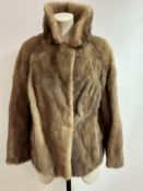 A Lady's brown Mink jacket with fold over collar and slash pockets to side and satinised lining with