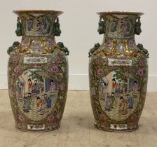 A large decorative pair of Chinese Canton porcelain vases in the famille vert pallet, each decorated