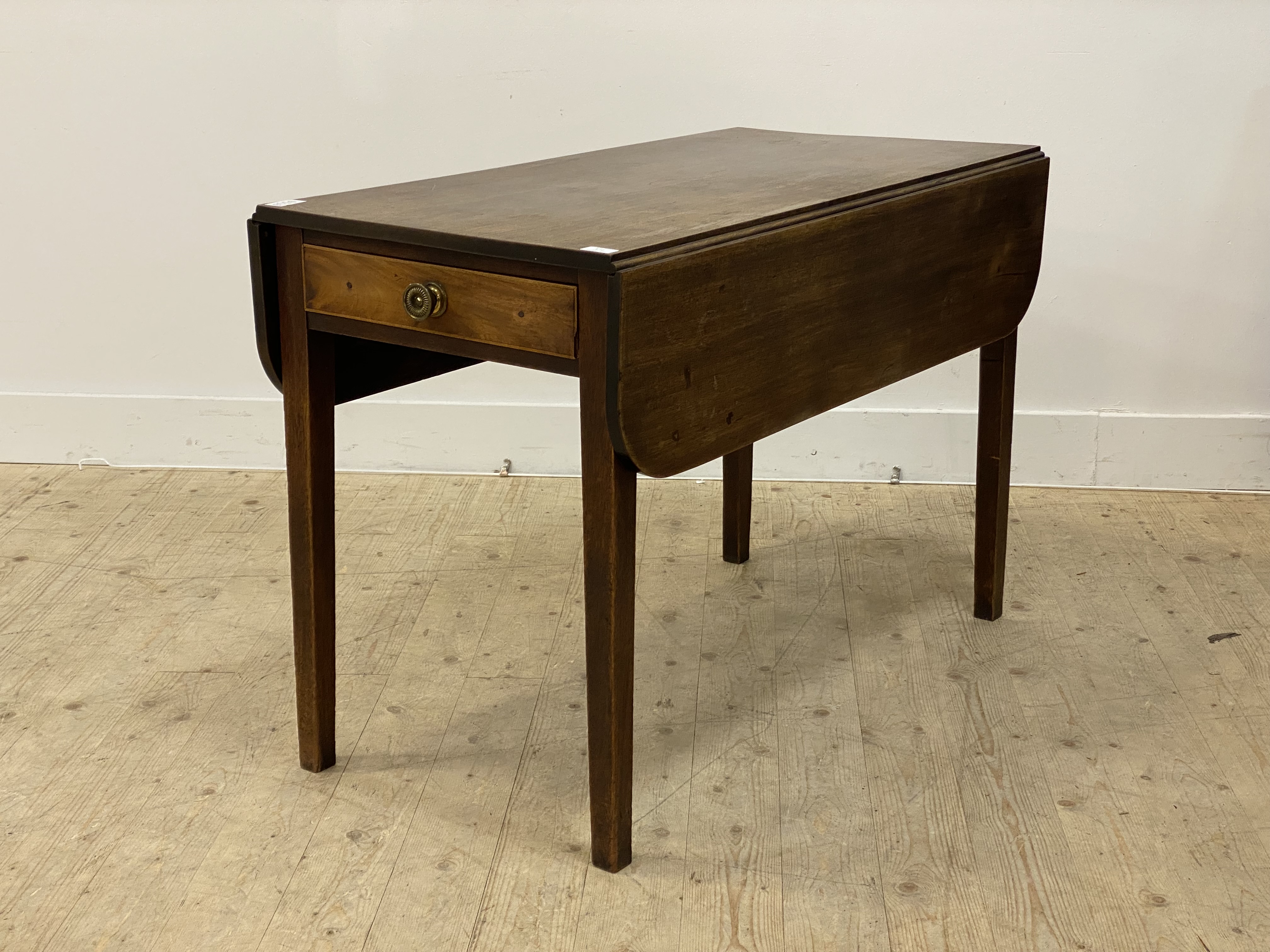 A George III mahogany Pembroke table, the rectangular top with two drop leaves above a drawer to one