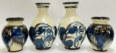 Two pairs of Danish Danico art pottery vases with tube lined decoration comprising a pair of squat
