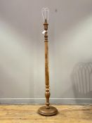 An Indian teak lamp standard, the turned and floral carved column on a circular base. H157cm.