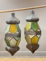 A pair of candle holder lanterns of faceted octagonal form, with openwork decoration and stained and