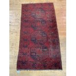 A hand knotted Afghan Bokhara rug of characteristic design 210cm x 117cm.