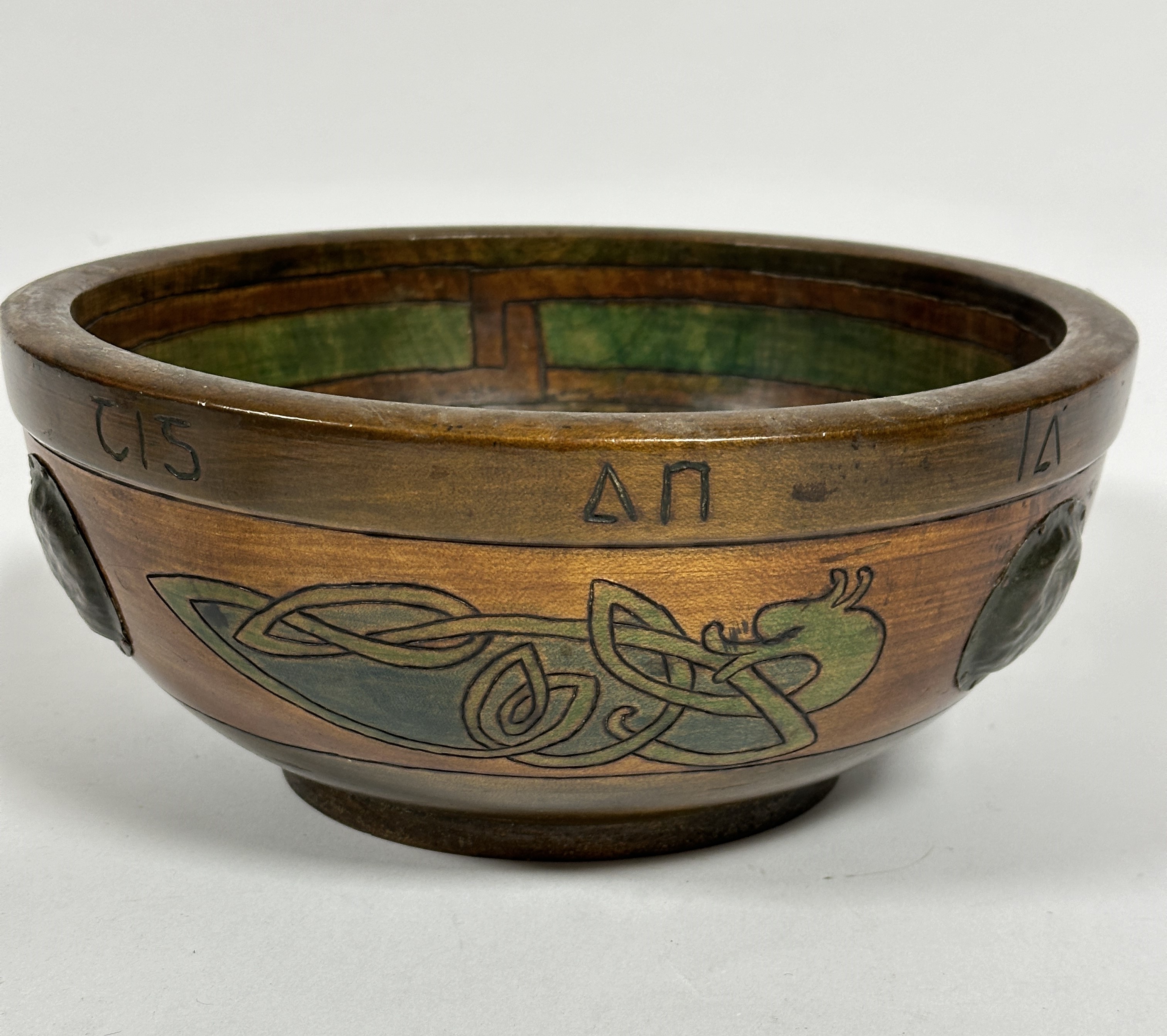A Irish Arts and Crafts treen carved bowl with hand carved celtic decoration and circular copper