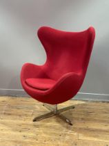 After Arne Jacobsen, a vintage reproduction egg chair, upholstered in red synthetic wool, raised