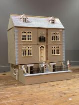 A large kit built model dolls house formed as a three story Georgian town house with pitched roof