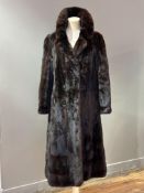 A 1980s dark ranch Mink lady's full length coat with fold down collar, satin lining and belt to back