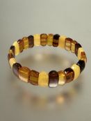 A four coloured amber expanding bracelet, (each panel x 0.5 cm x 1 cm) 9.9g