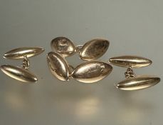 A pair of 15ct gold bean shaped unengraved sleeve links with chain link fastenings, (L x 2 cm), 9.2g