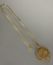 A Edward VII 1906 gold half sovereign mounted in fancy 9ct gold mount on 9ct gold chain, (chain L